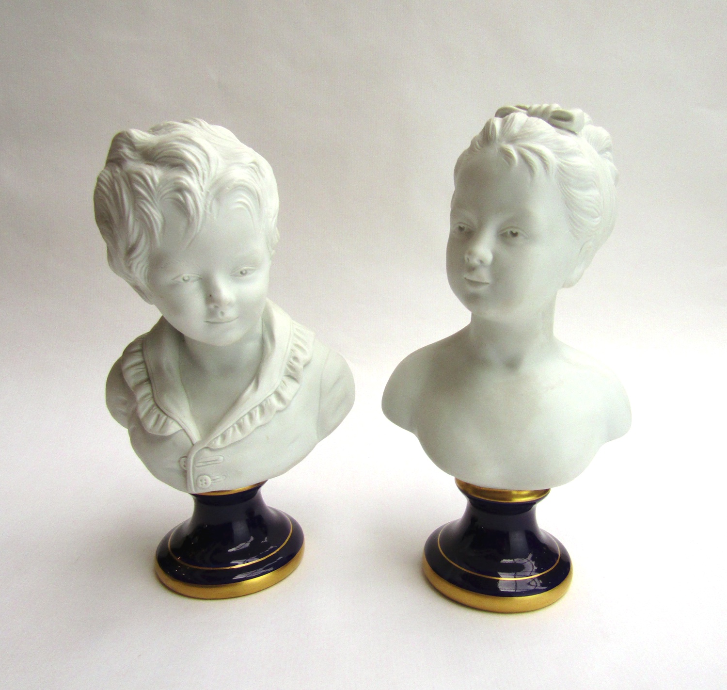 Pair of French Bisque Porcelain (After Houdon) Busts of Young Boy and ...